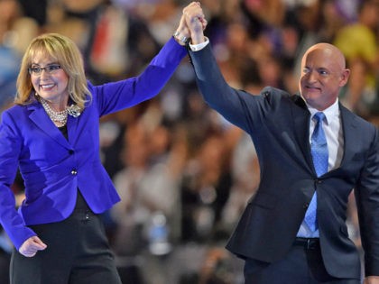 Former Congresswoman Gabby Giffords (L) and her husband and former astronaut Mark Kelly leave the stage during the third evening session of the Democratic National Convention at the Wells Fargo Center in Philadelphia, Pennsylvania, July 27, 2016. / AFP / Nicholas Kamm (Photo credit should read NICHOLAS KAMM/AFP/Getty Images)