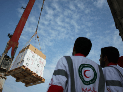 Iranian Red Crescent aid workers observe loading medical aid onto the 'Iran Shahed&#0