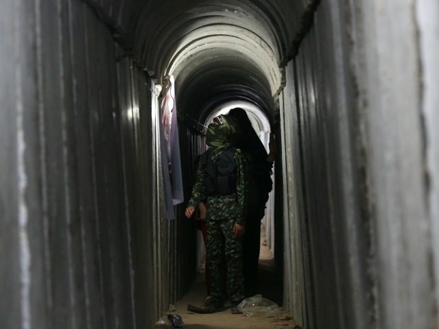 A Palestinian boy walks inside a tunnel used for military exercises during a weapon exhibi
