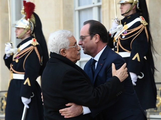 French President Francois Hollande (R) welcomes Palestinian president Mahmud Abbas (L) at
