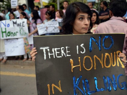 PAKISTANI HUMAN RIGHTS ACTIVISTS HOLD PLACARDS DURING A PROTEST IN ISLAMABAD ON MAY 29, 2014. AAMIR QURESHI/AFP/GETTY IMAGES