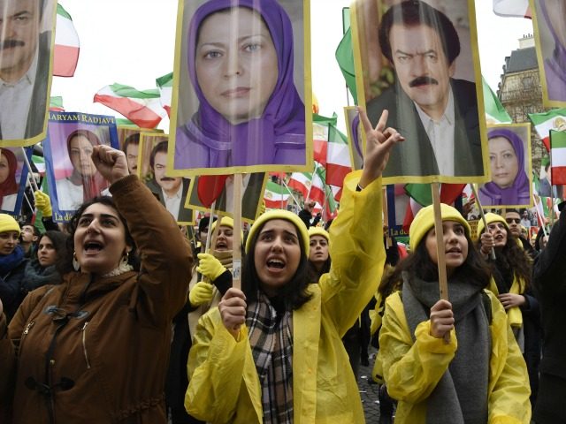 A woman holds a picture of Maryam Rajavi, president elect of National Council of Resistanc