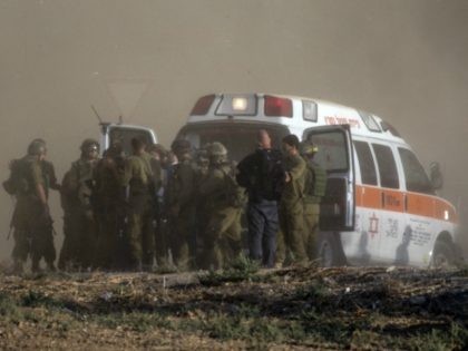Israeli soldiers evacuate their wounded comrades at an army deployment area along the Israeli border with the Gaza Strip on July 28, 2014. The Israeli army said five of its soldiers have been killed in and around the wartorn Gaza Strip. AFP PHOTO / JACK GUEZ (Photo credit should read …