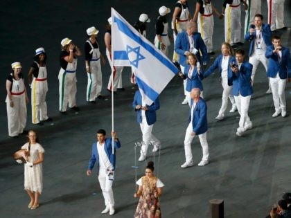LONDON, ENGLAND - JULY 27: Israel's flagbearer Shahar Zubari holds the national flag as he leads the contingent in the athletes parade during the opening ceremony of the London 2012 Olympic Games at the Olympic Stadium on July 27, 2012 in London, England. (Photo by Fabrizio Bensch - IOPP Pool …