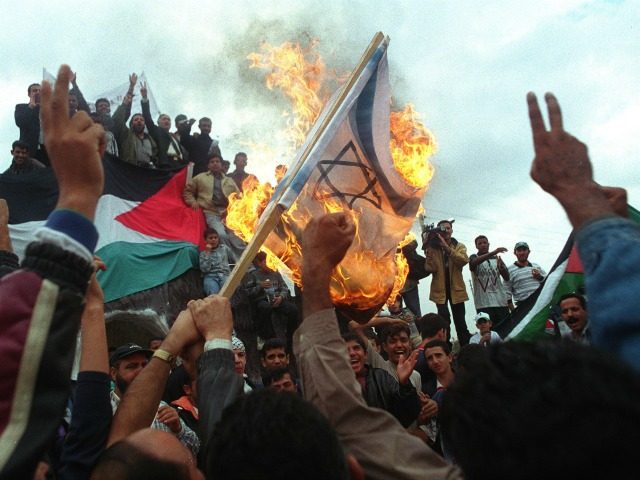 Jordanian anti-Israeli protesters burn an Israeli flag October 24, 2000 after marching in support of Palestinians toward Jordan's border with the West Bank. More than10,000 demonstrators took part in a rally where more than 20 persons were injured . The 'return march' was called to demand the right of return …