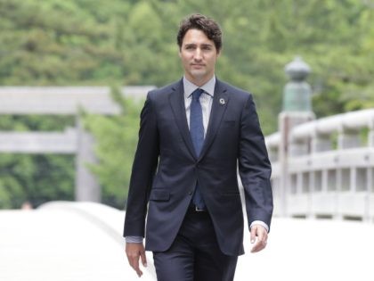Canadian Prime Minister Justin Trudeau walks on the Ujibashi bridge as he visits at the Is