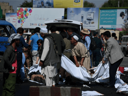 Afghan volunteers carry the bodies of victims at the scene of a suicide attack that targeted crowds of minority Shiite Hazaras during a demonstration at the Deh Mazang Circle of Kabul on July 23,2016.