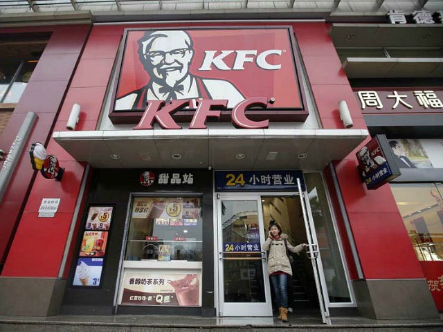 A woman walks out from a KFC restaurant as she speaks on her mobile phone in Wuhan, Hubei province, February 5, 2013. REUTERS/STRINGER