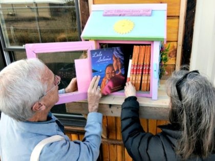 In this Thursday, Dec. 6, 2012 photo, Rick Brooks, left, looks through the small glass doo