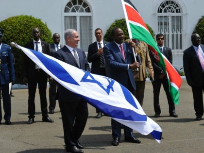 Israeli Prime Minister, Benjamin Netanyahu (L) and Kenya's President Uhuru Kenyatta hold Israeli and Kenyan national flags after a join press conference in July 5, 2016 at the State House, in Nairobi.