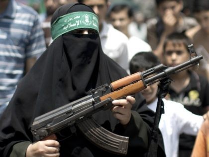 A Palestinian woman Hamas supporter hold up a rifle during a protest against the kidnappin
