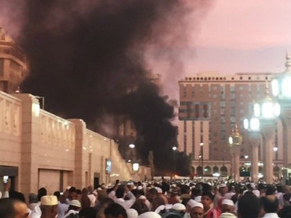 In this photo provided by Noor Punasiya, people stand by an explosion site in Medina, Saudi Arabia, Monday, July 4, 2016. State-linked Saudi news websites reported an explosion Monday near one of Islam's holiest sites in the city of Medina, as two suicide bombers struck in different cities. (Courtesy of …