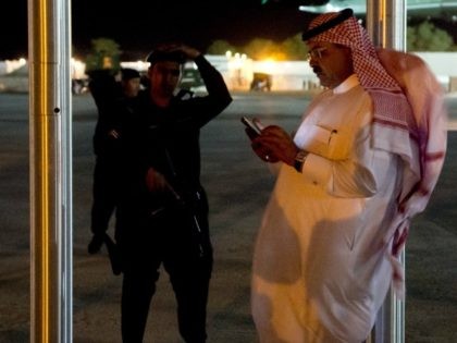 A Saudi man using a cellphone stands near Marine One, with US President Barack Obama aboard, as he departs meetings with King Abdullah of Saudi Arabia at the King's Desert Camp at Rawdat Khuraim outside Riyadh, Saudi Arabia, March 28, 2014. AFP PHOTO / Saul LOEB (Photo credit should read …