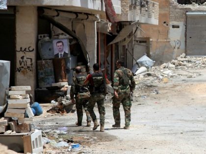 Syrian army soldiers patrol in government-controlled Aleppo's al-Khalidiya area where the army progressed towards the industrial zone of al-Layramoun and Bani Zeid on June 28, 2016. Aleppo was once the country's commercial hub but now lies divided between government forces in the west and rebels in the east. / AFP …