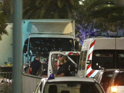 French police forces and forensic officers stand next to a truck July 15, 2016 that ran in