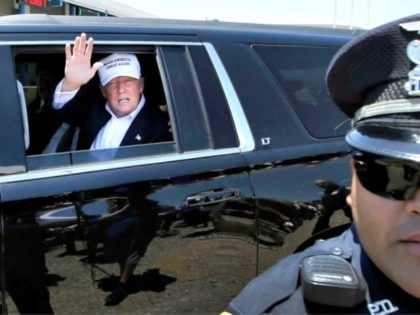 Republican presidential hopeful Donald Trump waves from his vehicle during a tour of the the World Trade International Bridge at the U.S. Mexico border in Laredo, Texas, Thursday, July 23, 2015. (AP Photo/LM Otero)