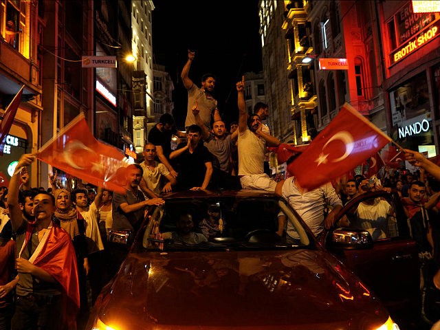 People chant slogans during a pro-government rally in central Istanbul's Taksim square, Sa
