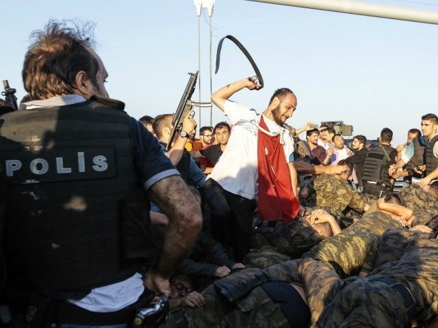 An unidentified man uses his belt to hit Turkish soldiers involved in the coup attempt that have now surrendered on Bosphorus bridge on July 16, 2016 in Istanbul, Turkey. Istanbul's bridges across the Bosphorus, the strait separating the European and Asian sides of the city, have been closed to traffic.Turkish …