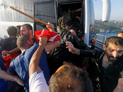 Soldiers push each other to board a bus to escape the mob after troops involved in the coup attempt surrendered on the Bosphorus Bridge in Istanbul, Turkey July 16, 2016. REUTERS/MURAD SEZER/FILE PHOTO