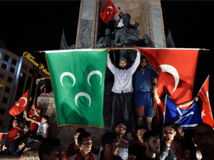 Pro Erdogan supporters hold Turkish national and Ottoman flags during a rally at Taksim square i istanbull on July 20, 2016 following the failed military coup attempt of July 15. Turkish President Recep Tayyip Erdogan on July 20, 2016 vowed that democracy would not be compromised in Turkey despite declaring …