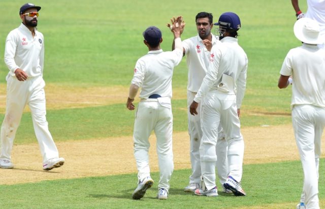 India bowler Ravichandran Ashwin celebrates with teammates after bolwing out Shane Dowrich
