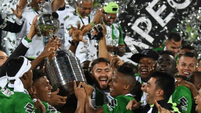 Colombia's Atletico Nacional players celebrate with the trophy after winning the 2016 Copa