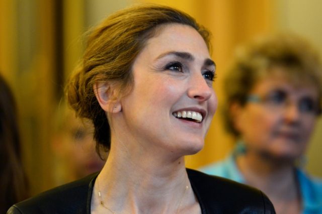 French actress Julie Gayet (R) reacts after the signature of the first partnership convent