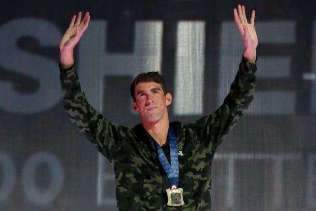 Michael Phelps of the United States participates in the medal ceremony for the Men's 100 M