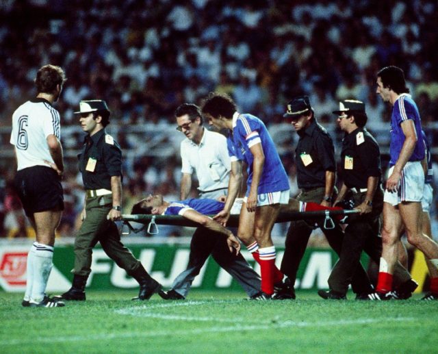 French defender Patrick Battiston is stretchered off the pitch after colliding with German