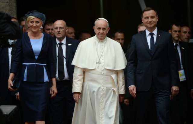Pope Francis (C) is welcomed by Polish President Andrzej Duda (R) and his wife Agata Kornh