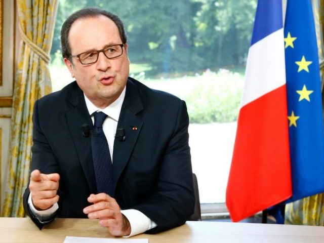 French President Francois Hollande gestures during an interview following the Bastille Day