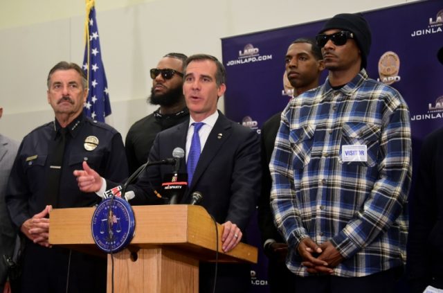 Los Angeles mayor Eric Garcetti addresses the media with police chief Charlie Beck (L) and