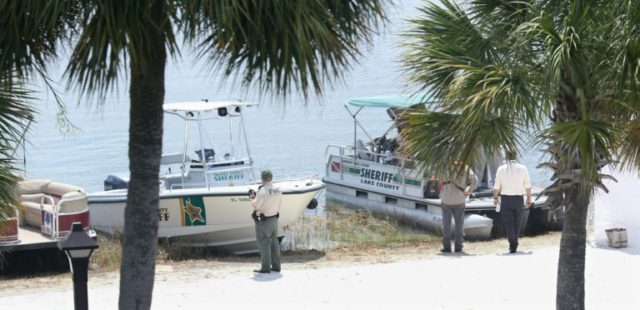 A law enforcement officer from the Florida Fish and Wildlife Conservation Commission (L) a