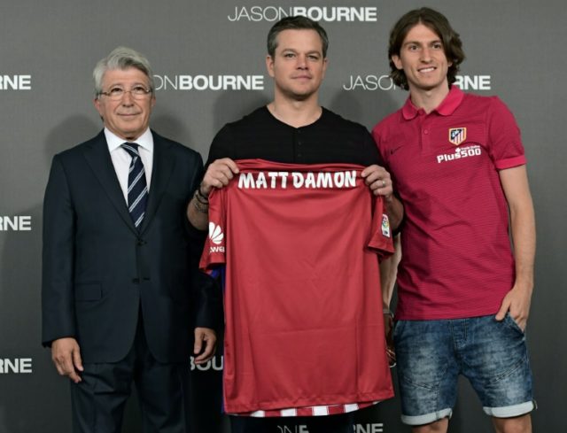 US actor Matt Damon (C) poses with a Club Atletico de Madrid jersey beside President Enriq