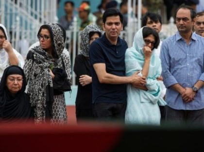 Family members of a Bangladeshi policeman mourn for him during a memorial service for thos