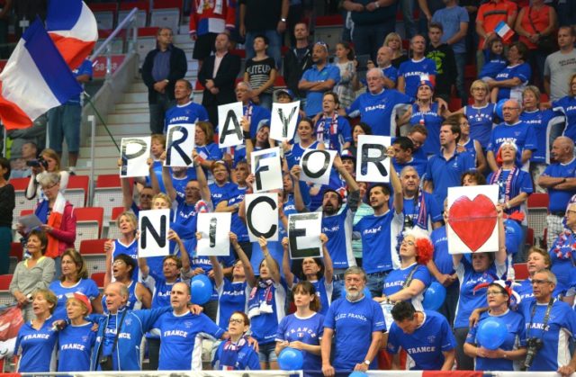Fans of the French Davis Cup team observe a minute of silence for the victims of the terro