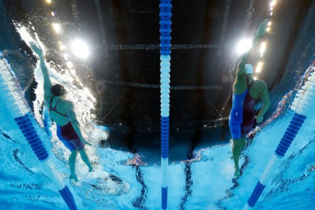 Missy Franklin and Elizabeth Beisel of the United States compete in a semi-final heat for