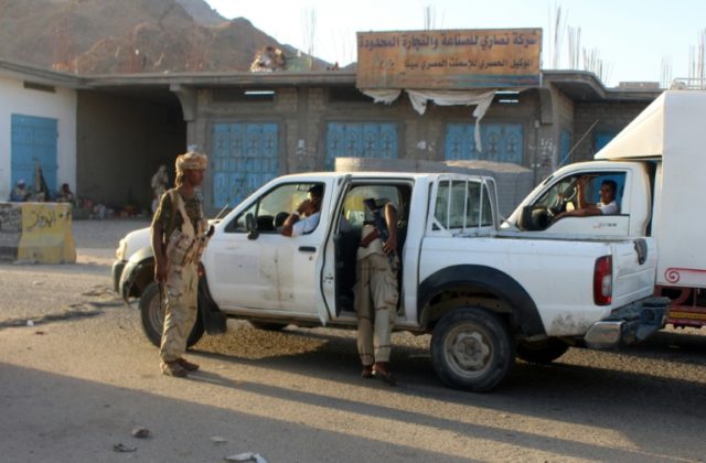 Yemeni troops search a vehicle at a checkpoint in the south-eastern port city of Mukalla,