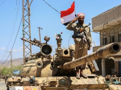 A Yemeni fighter loyal to the country's exiled president salutes at a checkpoint in the southwestern city of Taez