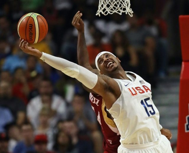 Carmelo Anthony of the United States grabs a rebound over Miguel Ruiz of Venezuela during