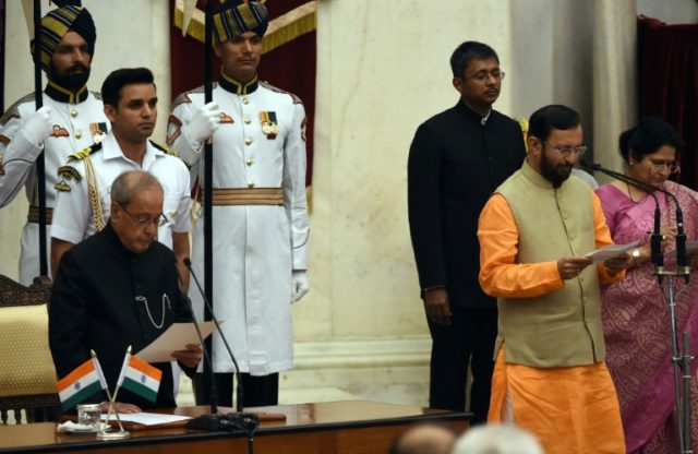 Bharatiya Janata Party (BJP) politician, Prakash Javadekar (right) takes the oath during t