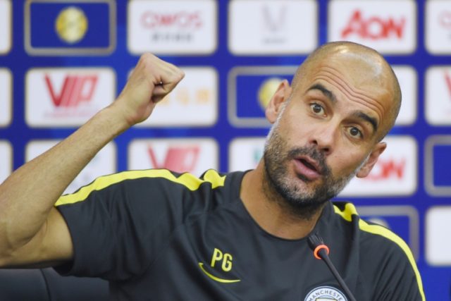 Manchester City manager Pep Guardiola attends a press conference in the Chinese city of Sh