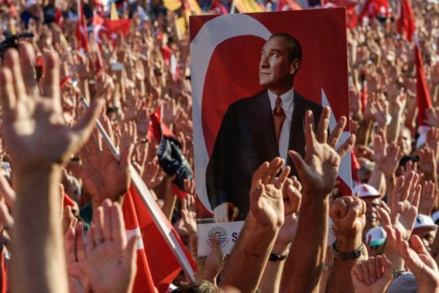 Demonstrators hold a portrait of Mustafa Kemal Ataturk, founder of modern Turkey, in Taksi