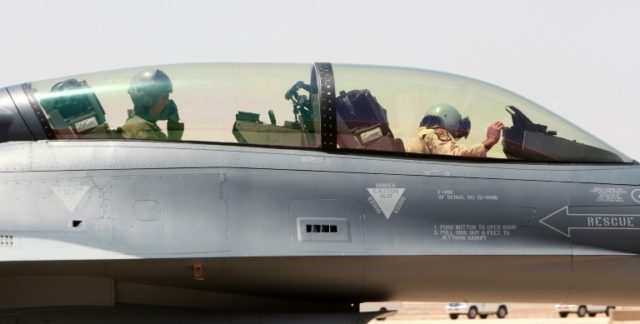 Military pilots sit in F-16 fighter jets on the tarmac at Iraq's Balad air base in the Sal
