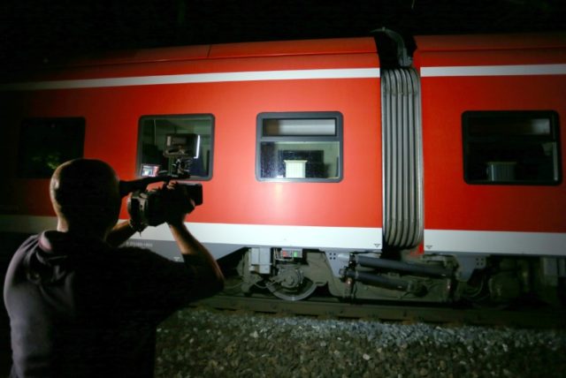 A cameraman films a regional train in Wuerzburg southern Germany on July 18, 2016 after a