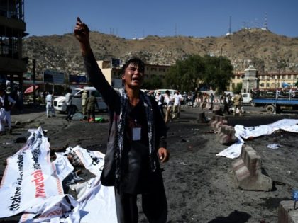 A protester screams near the scene of a suicide attack that targeted crowds of minority Sh