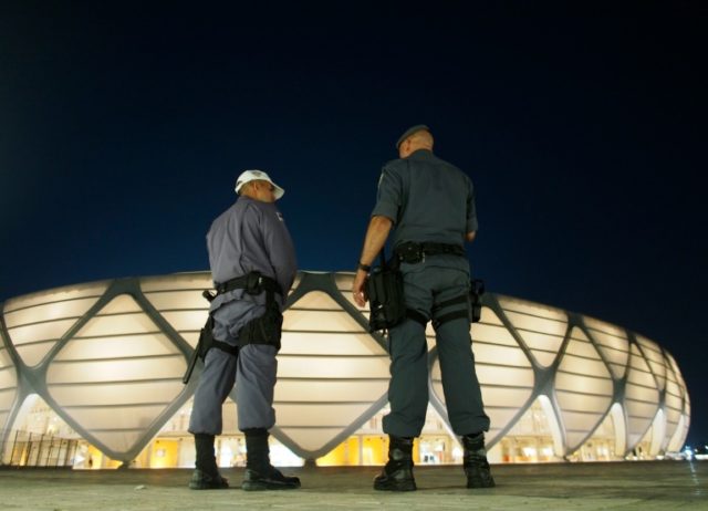 Police officers stand guard outside the Amazonia Arena in Brazil