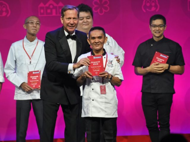 Michael Ellis, international director of the Michelin guides, presents a Michelin star awa