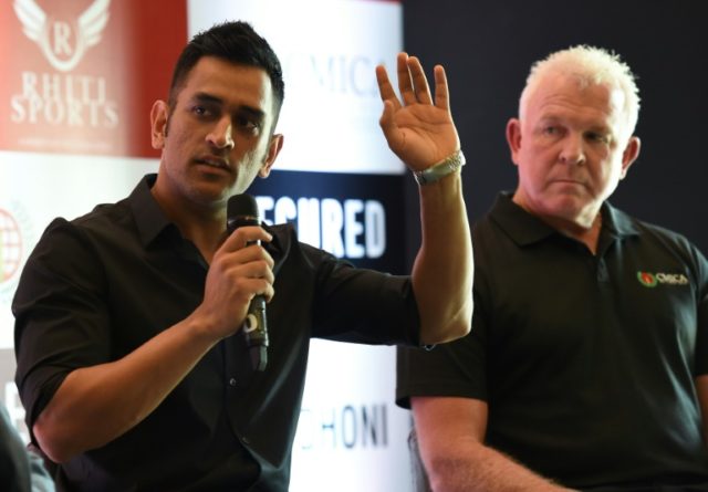 India cricket captain Mahendra Singh Dhoni (L) speaks as former Australian cricketer Craig
