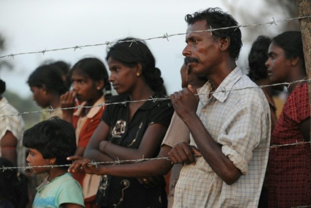 Displaced Tamil civilians wait for food at Manic farm in the northern Sri Lankan district